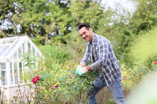 Bethnal Green gardener using PPE during maintenance work