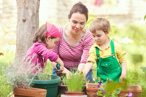 Professional gardeners following a health and safety policy during maintenance